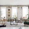 Adair side table in a minimalist room setting with distressed white walls and hardwood flooring