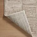 Rug corner lifted to show detailed weave on the underside and finished binding