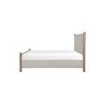 Warren Bed side view showing headboard height and fabric upholstery in beige with wood posts
