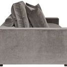 Side profile displaying sofa’s thick armrest and layered cushions with rounded bolsters