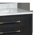 Side-angle close-up of vanity corner showing white Carrara marble countertop and gold-accented drawer pulls
