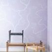 Three Paris Benches in black, driftwood, and natural finishes arranged in front of patterned wall