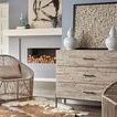 Montego Lounge Chair in living room setting beside console and fireplace on cowhide rug