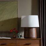 Daxton Table Lamp styled on wooden cabinet with decor and framed artwork in warm room setting