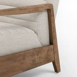 Close-up of wood grain texture and angular armrest joint detail on recliner