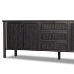 Detailed view of upper smooth wood top surface and woven cane drawer fronts with visible grain.