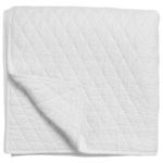 White quilt folded showing corner flipped to reveal quilted diamond pattern on both sides