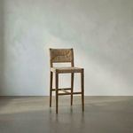 Bran Barstool shown from front view in minimal room setting with soft natural light and concrete floor