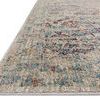 Close-up angled view highlighting the rug's colorful border with hints of rust and blue tones