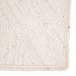 Close-up corner view of Vero ivory jute rug highlighting tight woven natural fiber texture
