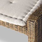 Close-up corner view of rattan weaving near seat cushion’s stitched edge