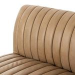 Close-up of vertical channeling detail on banquette’s leather upholstery at seating and back