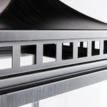 Detail close-up of square cutouts beneath the lantern's top edge showing brushed metal texture