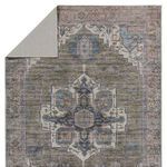 Back side of the rug flipped over showing light solid backing and stitched edges