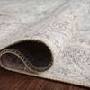 Rolled edge of Loren Silver Slate Rug revealing soft polyester base and printed surface texture