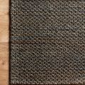 Corner detail of Lily Blue Rug on wood floor highlighting the weave and subtle color shifts