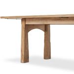 Under-table shot emphasizing arched supports and sturdy tapered legs
