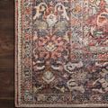 Top-down close crop of rug corner on dark wooden floor displaying detailed weave and vintage color tones