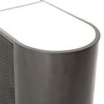 Close-up showing perforated metal door with small round holes and black slim door edges