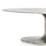 Three-quarter perspective emphasizing sleek tulip pedestal connecting base and tabletop
