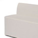 Partial front corner angle showing slipcover's smooth fit and tight construction on bench.