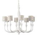 Alternate angle of chandelier with eight patterned fabric lampshades featuring gold and brown spirals