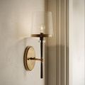 Side profile of Lyndall Wall Sconce showing slender black metal rod and antique brass mounting arm