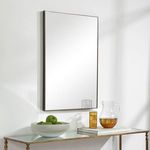 Side angle view of Owen Mirror showing frame depth and a glass pitcher and apples below