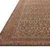Close-up angled view showing rug’s low pile and detailed woven border texture