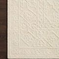 Corner of ivory Cecelia rug on dark wood floor highlighting texture and pattern depth