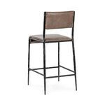 Rear view showing smooth leather backrest and hammered metal legs