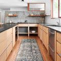 Narrow Teagan Denim Pebble Rug in kitchen setting with light wood cabinetry and black countertops, showcasing runner shape...