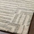 Close detailed view of rug's raised silver linear design with oatmeal background on wood floor