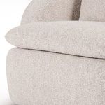 Angled right rear view showing rounded silhouette and loose cushion on backrest