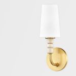 Side view of Casey wall sconce showing curved brass arm and round back plate
