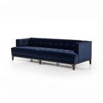 Front-facing view highlighting deep tufting and low-profile design in navy velvet