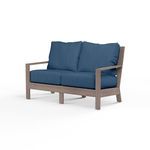 Laguna Loveseat outdoor sofa with driftwood-finish aluminum frame and deep blue cushions