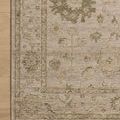 Corner of Willa Dove Forest Rug on light wood floor showing detailed floral motifs and border design