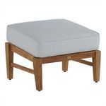 Teak ottoman with textured gray cushion in outdoor setting with visible grain wood frame