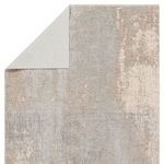 Top corner flipped to reveal light beige woven backing fabric underneath