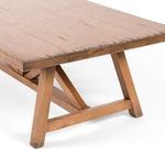 Angled view focusing on the sturdy X-shaped wooden base and slightly weathered legs