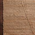 Detailed corner close-up of rug highlighting dense jute weave and subtle color variations