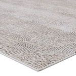 Close-up angle showing raised texture and plush pile of the cream and gray patterned rug