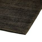 Close-up of the darker Blanton Outdoor Rug highlighting texture and organic patterned loops