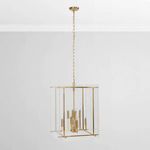 Full chandelier hanging in white room with visible chain and ceiling canopy against light gray wall