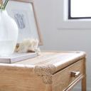 Close-up of rope wrapping on corner joint and wood grain on drawer front.