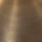 Brushed brass surface texture of Egon floor lamp’s conical lampshade