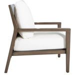 Side profile of lounge chair showing white cushions and aluminum oak-raffia frame