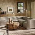 Styled in a room setting with warm neutral walls, wood coffee table, and natural light
