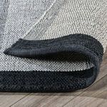 Rug edge curled upward revealing thickness and flexible construction